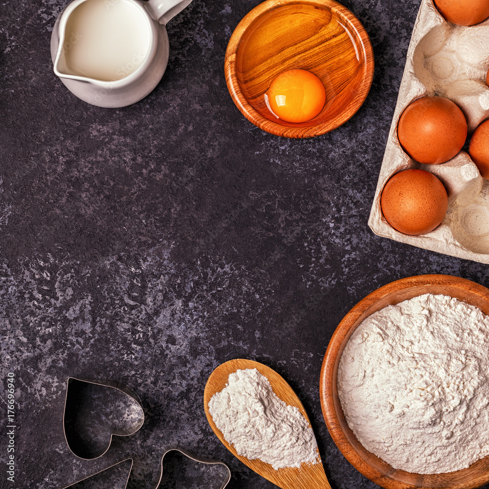 Ingredients for baking - flour, wooden spoon, rolling pin, eggs Ingredients for baking - flour, wooden spoon, rolling pin, eggs