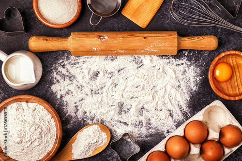 Ingredients for baking - flour, wooden spoon, rolling pin, eggs