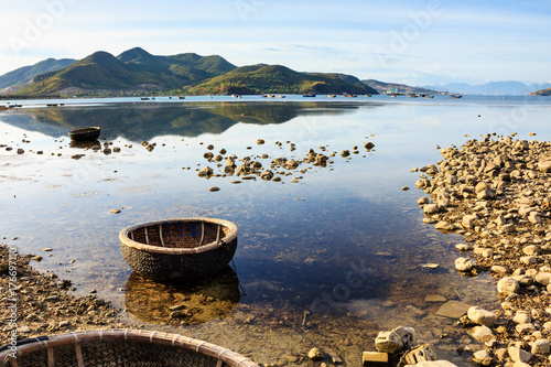 Basket boats at a lagoon on sunset in Song Lo, Phuoc Dong, Nha Trang, Vietnam. Nha Trang is well known for its beaches and scuba diving and has developed into a destination for international tourists.