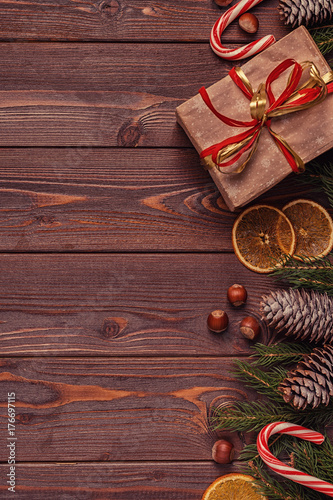Christmas gift boxes and fir tree on wooden background.