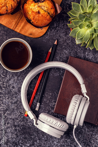 Schilderij op canvas Table with notepad, headphones and coffee.