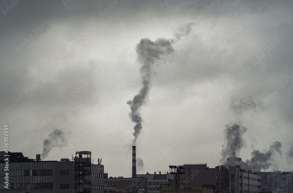 Pollution over city, industrial buildings and pollutions during gray day