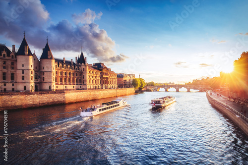 Dramatic sunset over Cite in Paris, France, with Conciergerie, Pont Neuf and river Seine. Colourful travel background. Romantic cityscape. photo