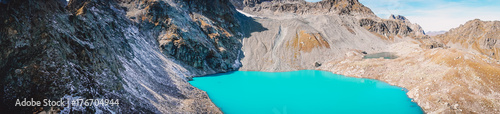 Panorama of beautiful mountain lake with turquoise water and rocky mountains