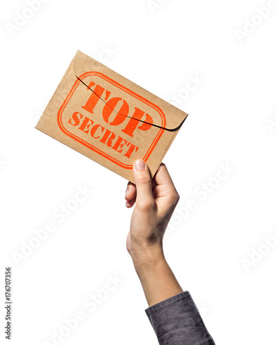Envelope with stamp top secret in the human hand. Isolated on white background.