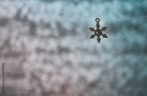 Beautiful metal toys on a niche in the background of a frozen window with beautiful patterns
