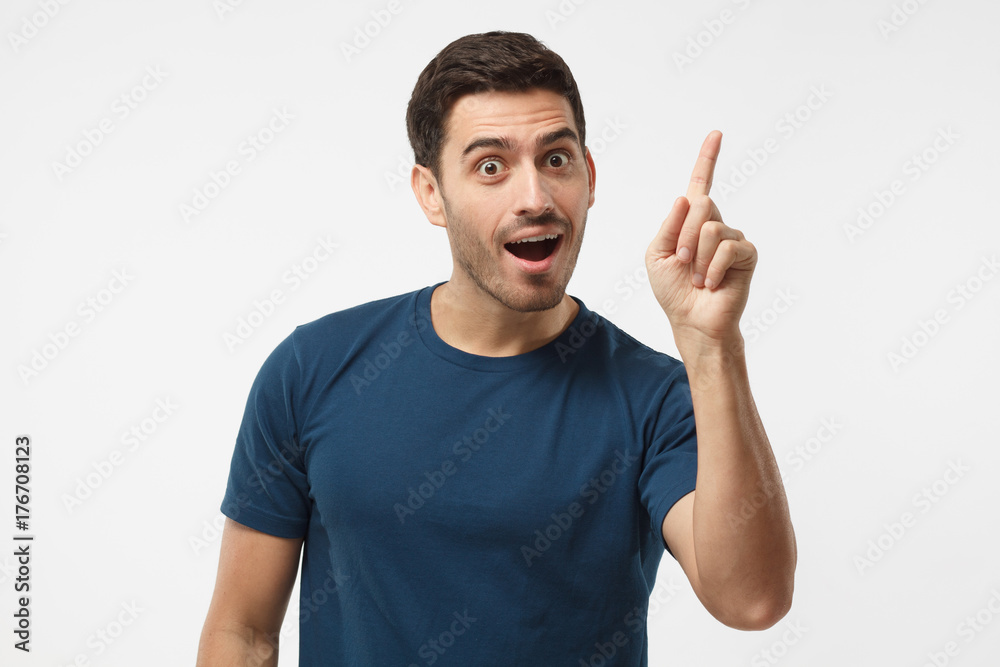 I got a solution! Photo of energetic nice smiling man wearing blue t-shirt isolated on gray background pointing finger in eureka sign, having great innovative idea, understanding I got a solution! Photo of energetic nice smiling man wearing blue t-shirt isolated on gray background pointing finger in eureka sign, having great innovative idea, understanding