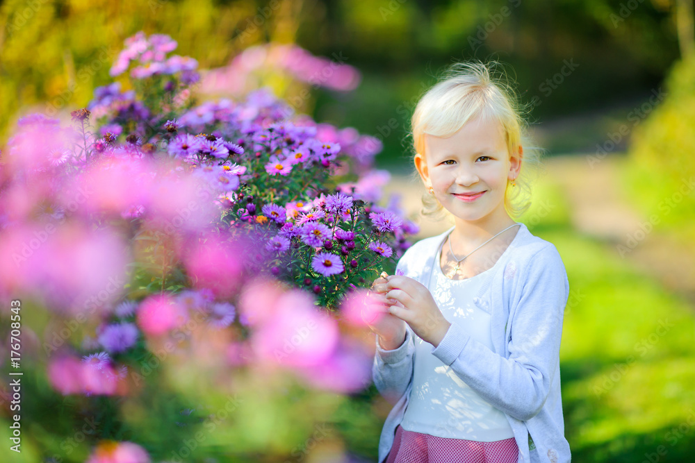 beautiful girl walks in the evening park, examines blooming flowers. beautiful girl walks in the evening park, examines blooming flowers.