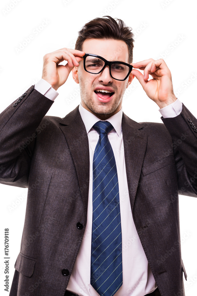Confident manager. Handsome young man in full suit adjusting his eyeglasses and looking at camera while standing against white background Confident manager. Handsome young man in full suit adjusting his eyeglasses and looking at camera while standing against white background