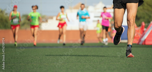 Marathon running race, people feet on the lawn