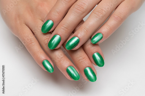 manicure green cat's eye on long oval, sharp nails 