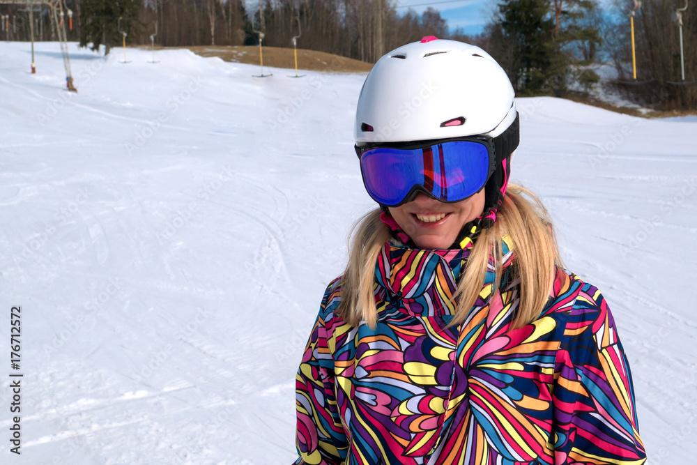 Portrait of young woman in helmet ski in winter time winter vacation.