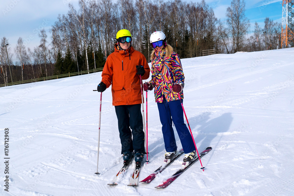 Happy mature couple skiing in the alps mountains senior man and woman enjoying ski vacation.