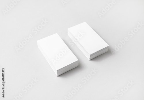 Blank white business cards with soft shadows on paper background. Template for ID with plenty of copy space.