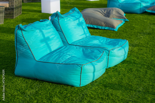 Beanbag : Blue cushioned seating on green grass at outdoor luxury garden