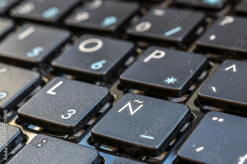 Close-up electronic of laptop keyboard with focus on ñ button, keyboard for writing in Spanish, Castilian