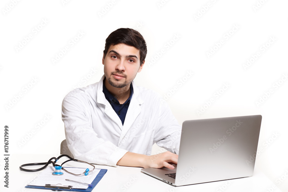 handsome doctor man in his office at the desk, looking at the lens handsome doctor man in his office at the desk, looking at the lens