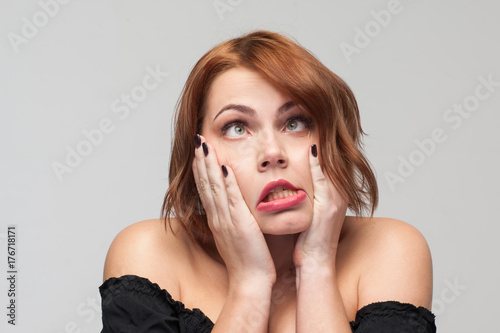 Forever young. Tired playful woman. Funny girl portrait on grey background with free space. Problems in life