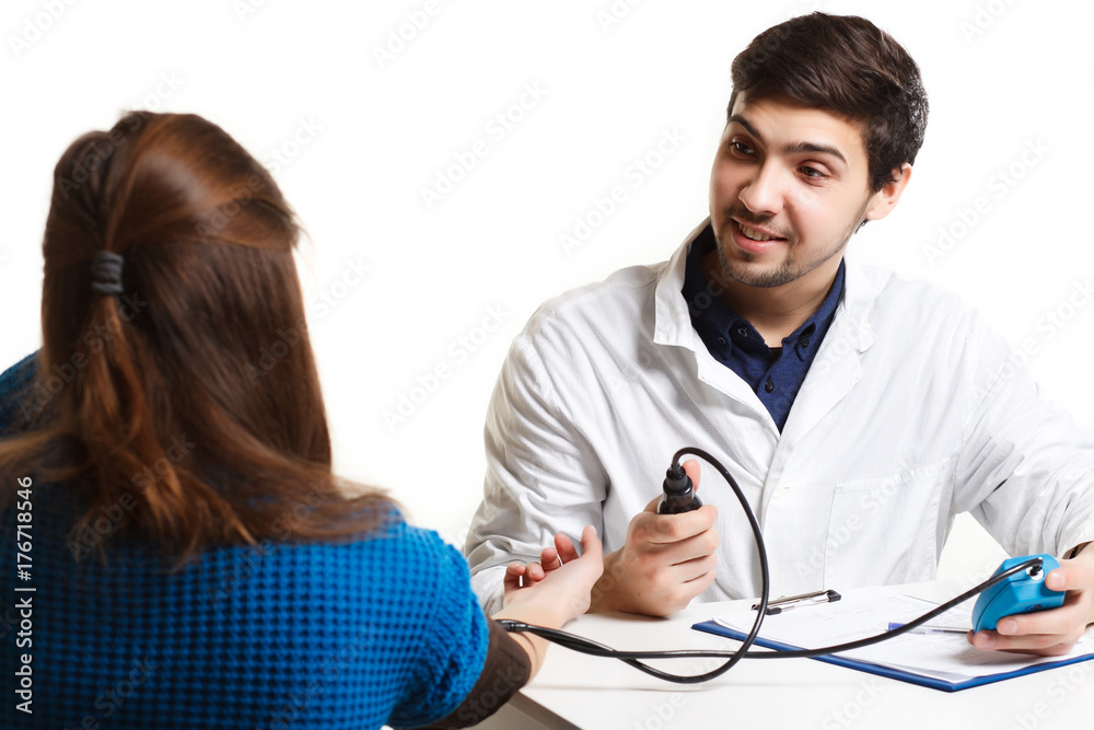 Doctor and patient blood pressure check up - Female patient's arm extended Doctor and patient blood pressure check up - Female patient's arm extended
