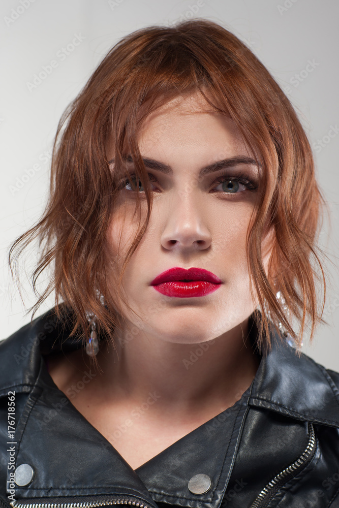 Modern stylish youth. Hairstyle advertising. Confident female, fashion woman portrait closeup on grey background. Fashionable hair commercial, style concept Modern stylish youth. Hairstyle advertising. Confident female, fashion woman portrait closeup on grey background. Fashionable hair commercial, style concept