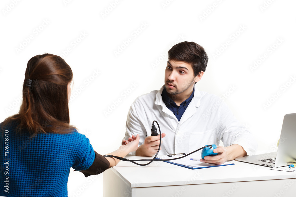 Doctor and patient blood pressure check up - Female patient's arm extended Doctor and patient blood pressure check up - Female patient's arm extended