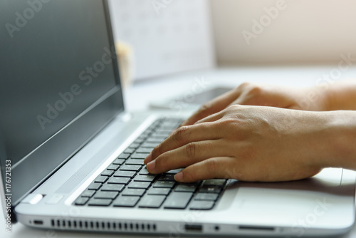 Woman working at home office hand on keyboard
