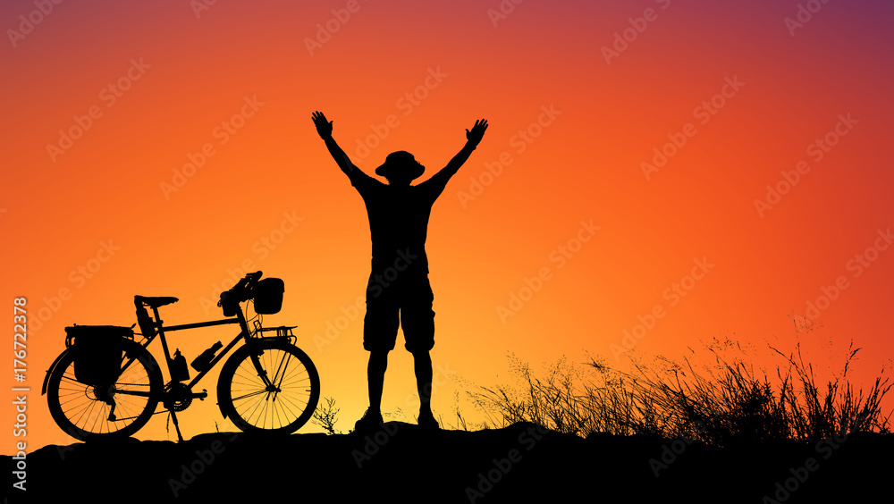 Silhouette man and bike relaxing with  sunrise background.