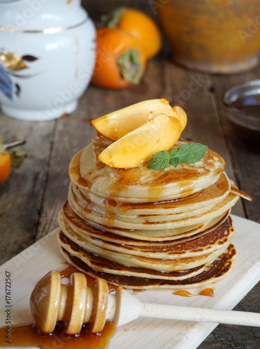 Pancakes with honey and persimmon