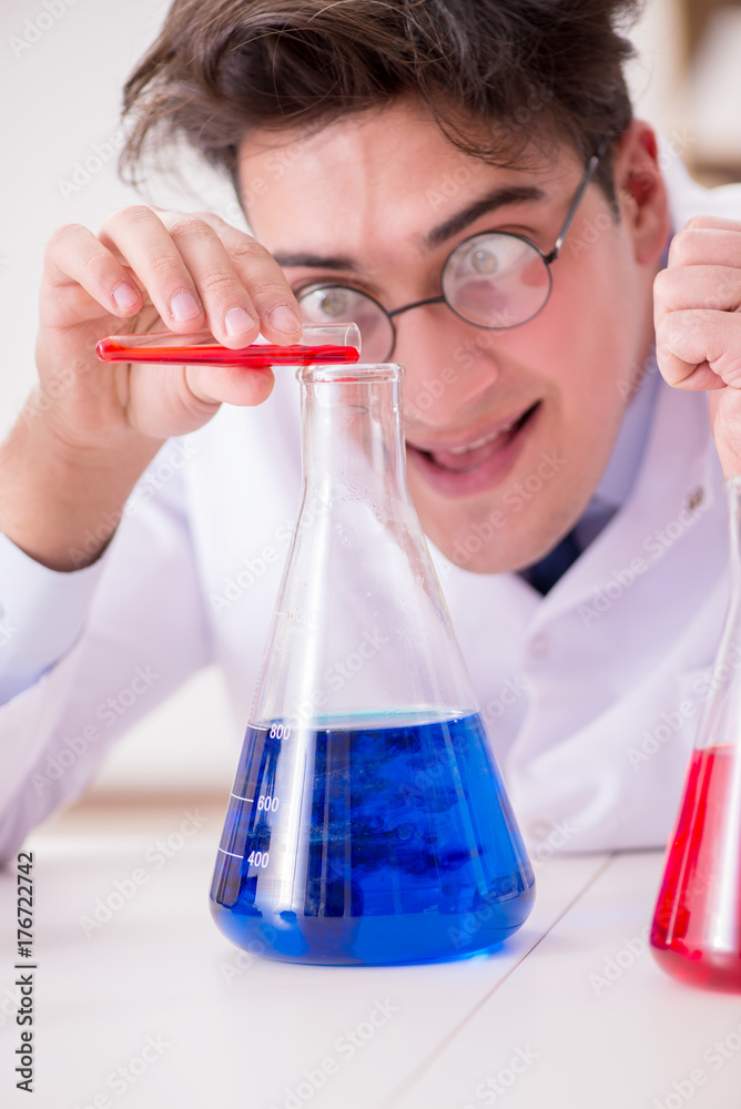Mad crazy scientist doctor doing experiments in a laboratory Mad crazy scientist doctor doing experiments in a laboratory