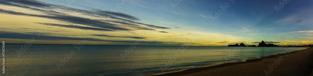 beautiful panorama landscape of sea at the beach at dusk in evening when sunset with golden light with mountain, blue sky and cloud  background. sky and sea twilight.