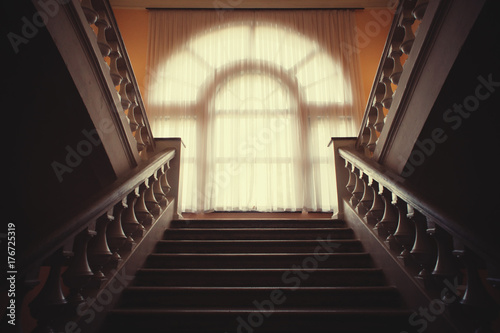 Stone staircase with window whitewashed curtains in the palace