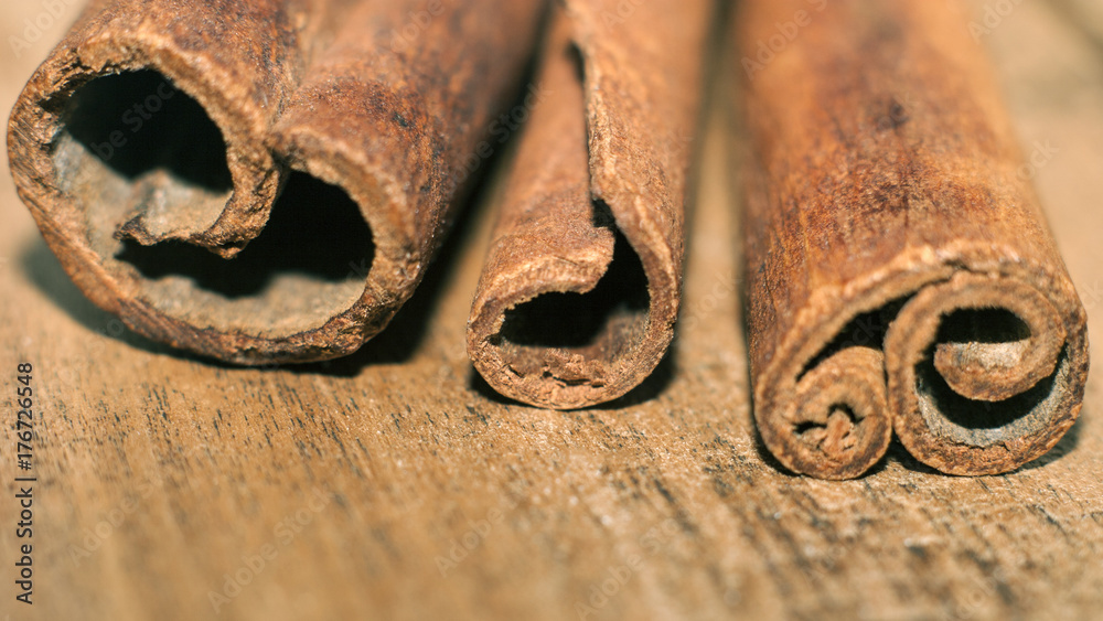 Sticks of fragrant cinnamon on wooden table close-up Sticks of fragrant cinnamon on wooden table close-up