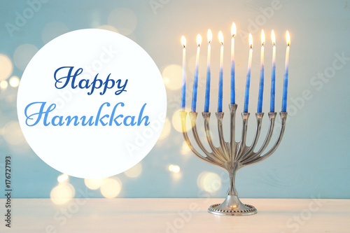 image of jewish holiday Hanukkah background with traditional menorah (traditional candelabra) and burning candles