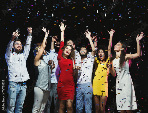 Happy young friends having party at night club