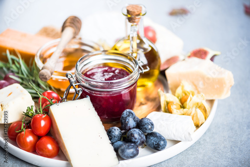 Cheese board with cranberry and autumn fruits