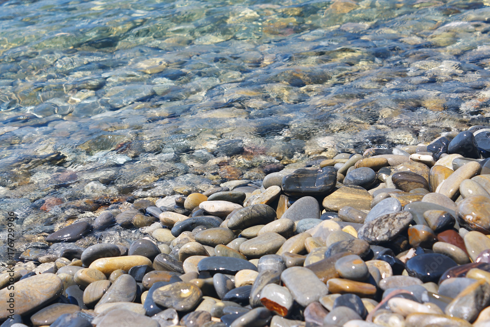 Amazing sea pebbles under water on the beach StockFoto Adobe Stock
