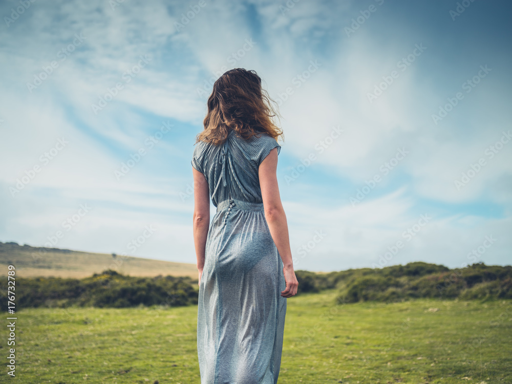 Beautiful young woman in dress on the moor Beautiful young woman in dress on the moor