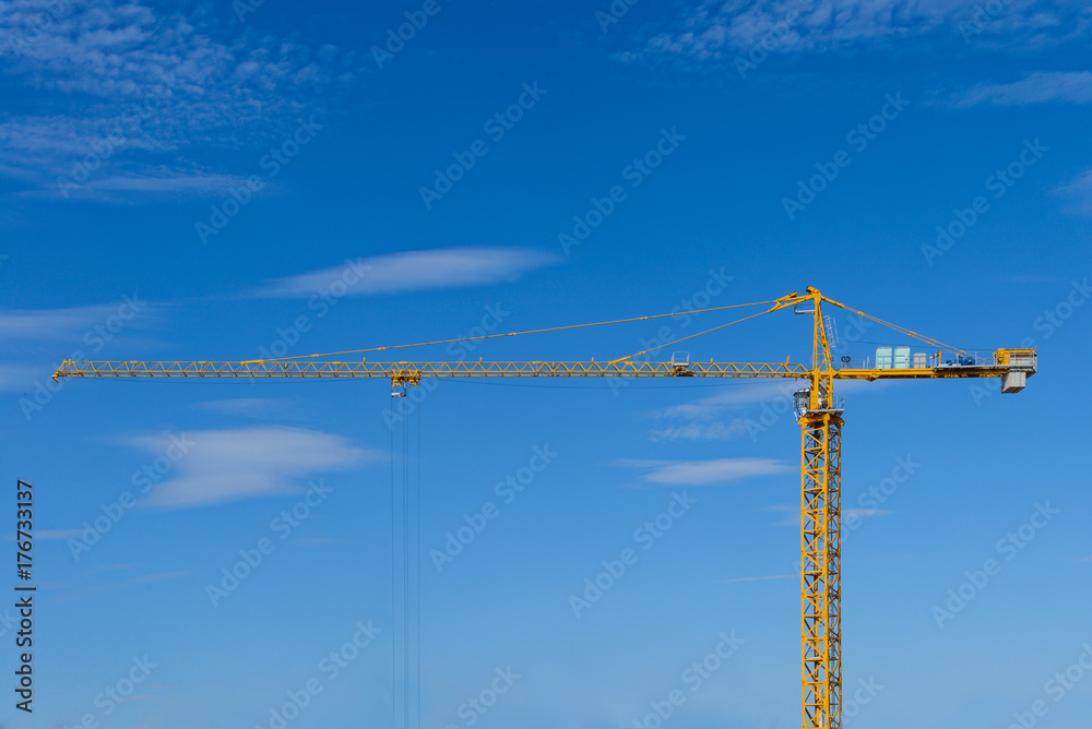yellow tower crane against the blue sky with clouds yellow tower crane against the blue sky with clouds