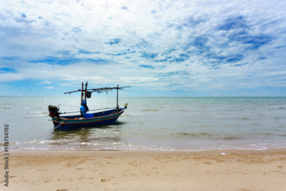 small local thai fishing boat parking or floating on the sea at the beach with blue sky and cloud in sunny day.