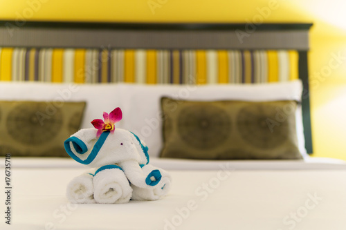 close up, Towels are folded into elephants shape for bathroom accessories preparation on the bed in a room of hotel or apartment. well preparation of bath facilities for hotel services for hotel guest