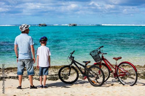 Father and kids at beach with bikes