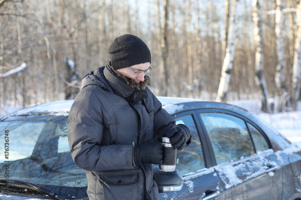 Man drink hot tea from mug outdoor in winter day