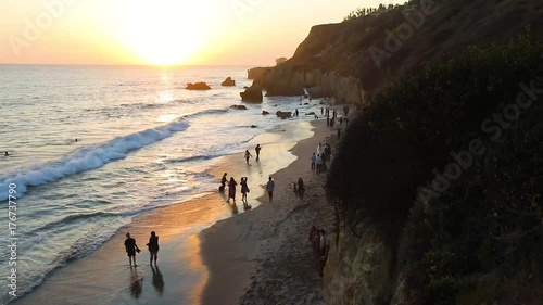 People at the beach at sunset
