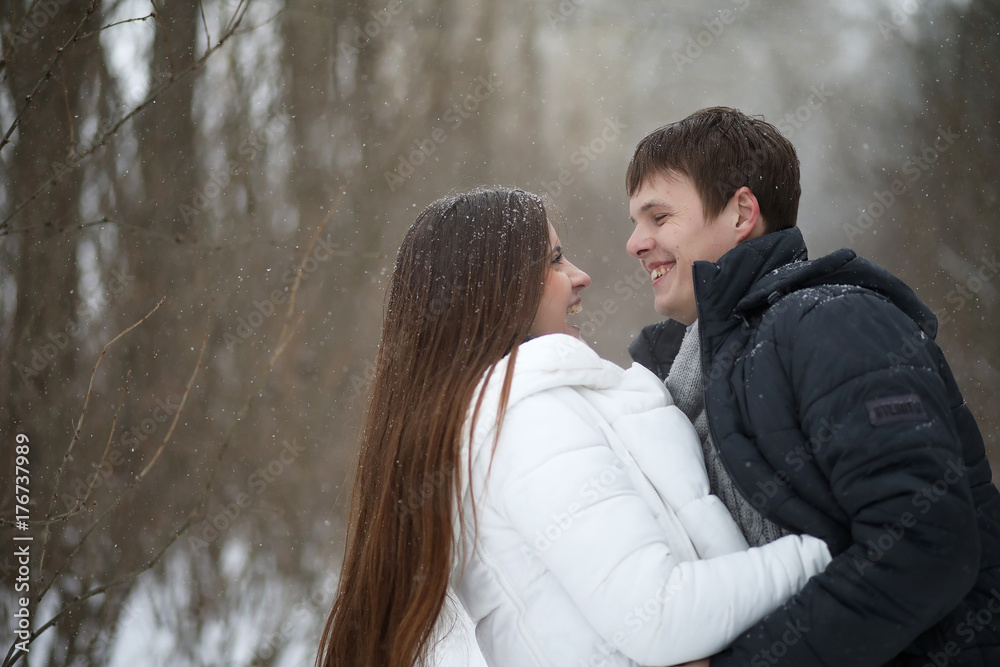 pair of lovers on a date winter afternoon in a snow blizzard pair of lovers on a date winter afternoon in a snow blizzard