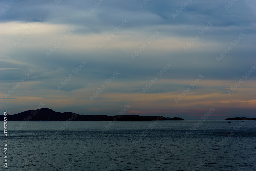 beautiful panorama landscape of sea at dusk in evening when sunset with multicolor light with mountain, blue sky and cloud  background. sky and sea twilight.