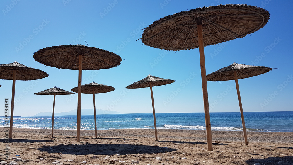 sea umbrellas shadows autum  in Preveza Greece
