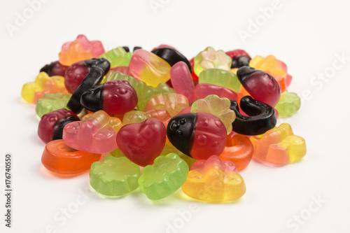 pile of fruity gummy candies with good luck symbols © seramoje