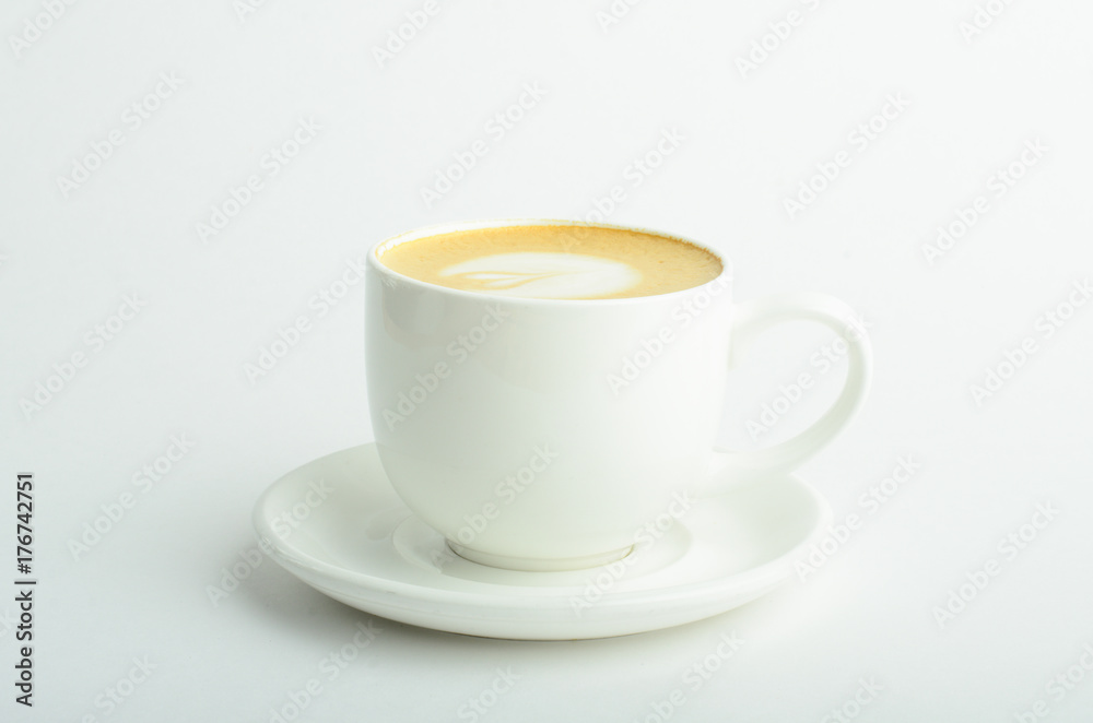 A cup of cappuccino coffee with heart shaped milk foam isolated on white background A cup of cappuccino coffee with heart shaped milk foam isolated on white background