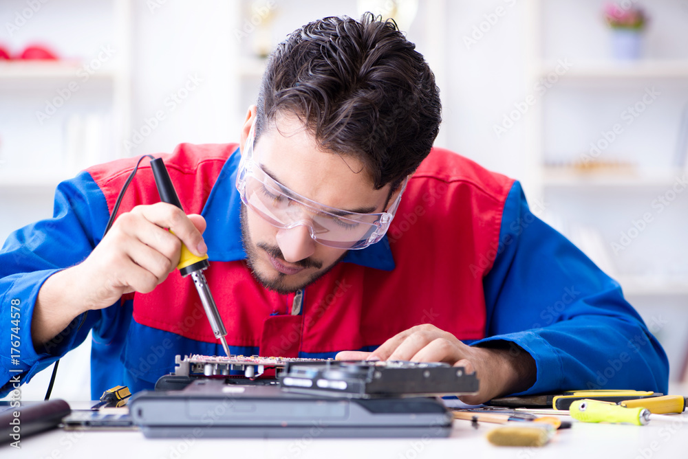 Repairman working in technical support fixing computer laptop tr Repairman working in technical support fixing computer laptop tr