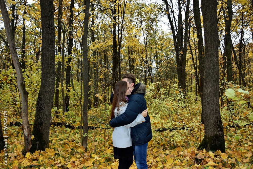 young loving couple in the autumn forest
